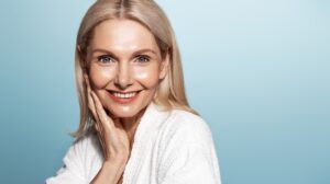 Older woman with shiny, smooth, and radiant skin after getting a Hydrafacial spa treatment