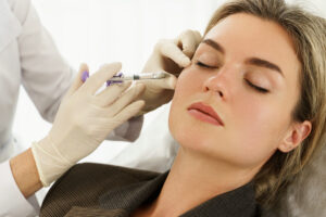Close-up of a beautiful woman getting Sculptra biostimulator injections to her face to boost collagen.